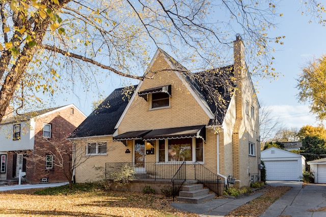 view of front of property with a garage and an outbuilding