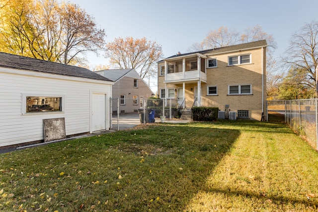 back of property with a yard and a balcony