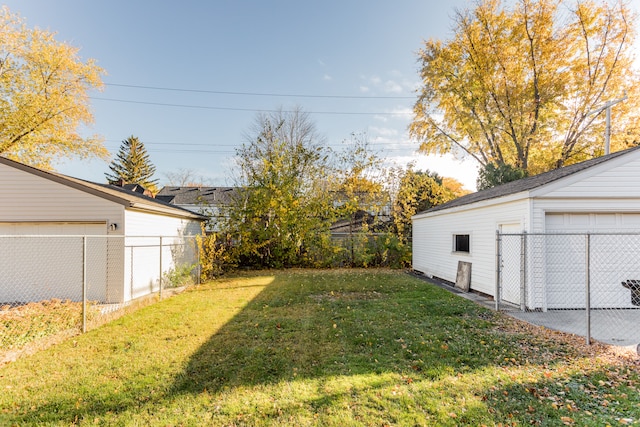 view of yard featuring an outbuilding and a garage