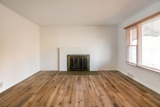 unfurnished living room with hardwood / wood-style flooring