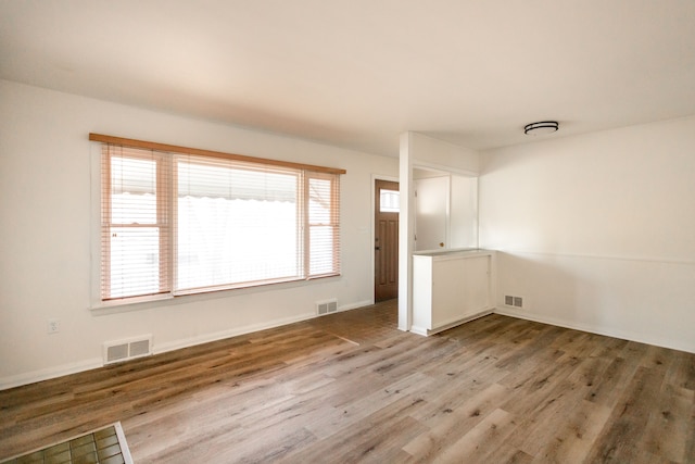 spare room with hardwood / wood-style floors