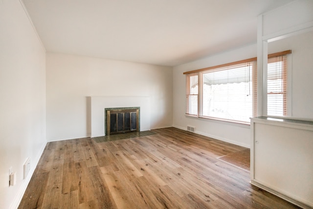 unfurnished living room with wood-type flooring