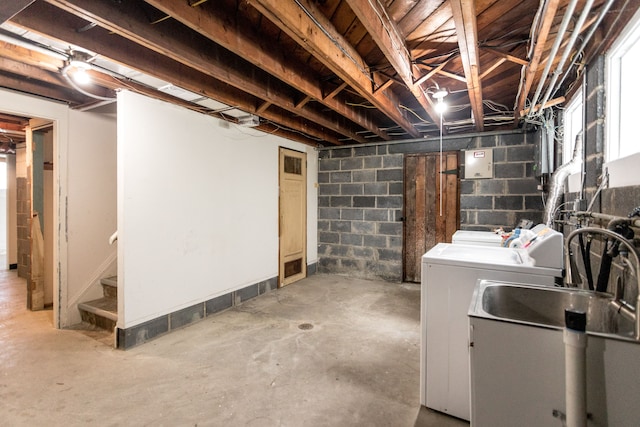 basement featuring separate washer and dryer and sink