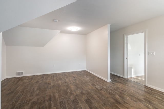 additional living space featuring dark hardwood / wood-style floors