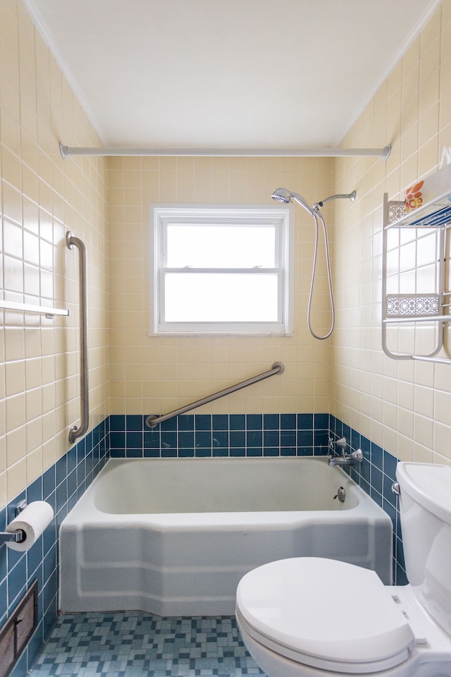 bathroom with tile patterned flooring, toilet, crown molding, and tile walls