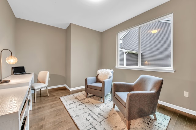 living area with light hardwood / wood-style flooring