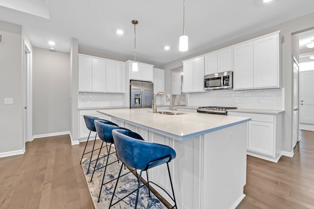 kitchen with sink, appliances with stainless steel finishes, and white cabinetry