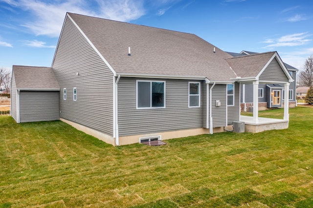 rear view of house featuring a yard