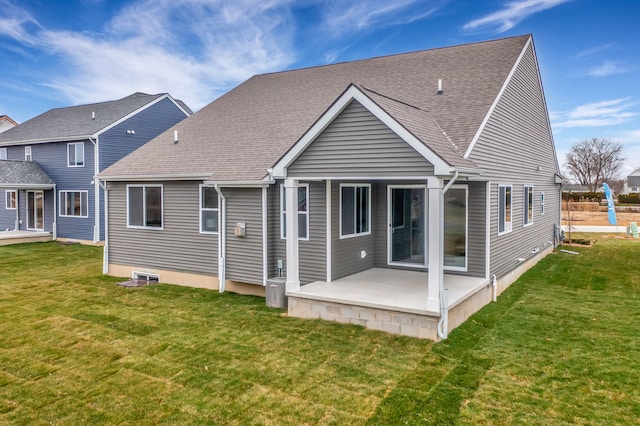 back of property featuring a lawn and a patio area