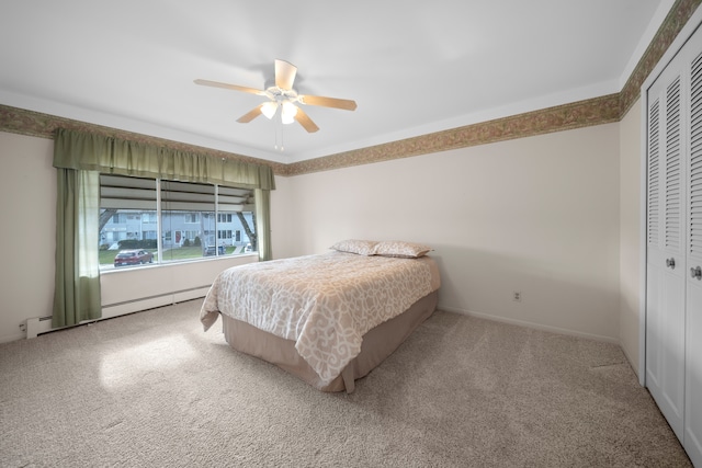 bedroom featuring carpet flooring, a closet, baseboard heating, and ceiling fan