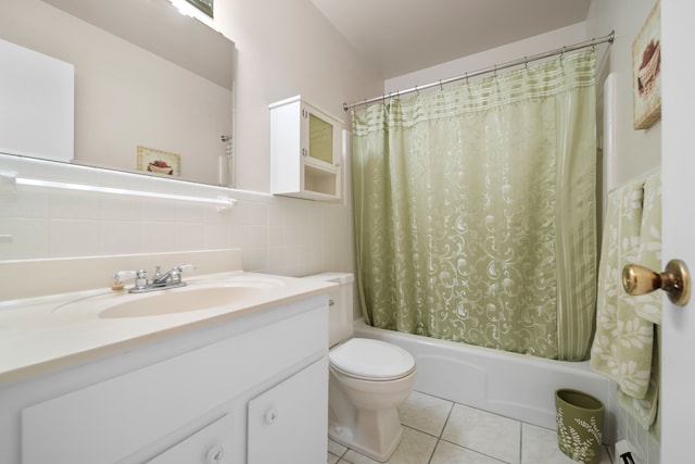 full bathroom with tile patterned floors, toilet, shower / tub combo with curtain, vanity, and tile walls