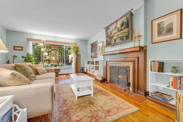 living room featuring radiator heating unit and hardwood / wood-style flooring