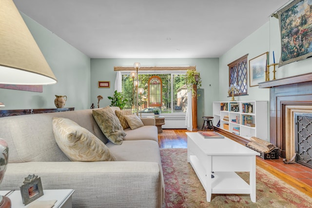 living room with radiator heating unit and light wood-type flooring