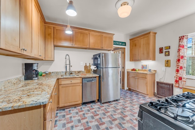 kitchen with sink, hanging light fixtures, light stone countertops, light brown cabinetry, and stainless steel appliances