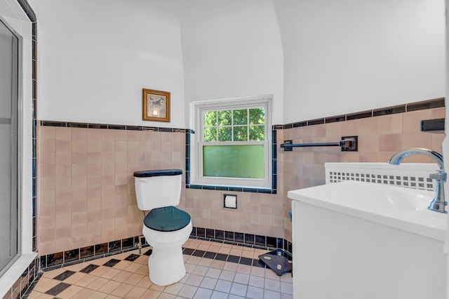 bathroom featuring an enclosed shower, sink, tile walls, tile patterned flooring, and toilet