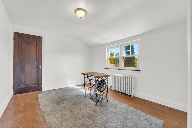 dining room with crown molding, radiator heating unit, wood-type flooring, and lofted ceiling