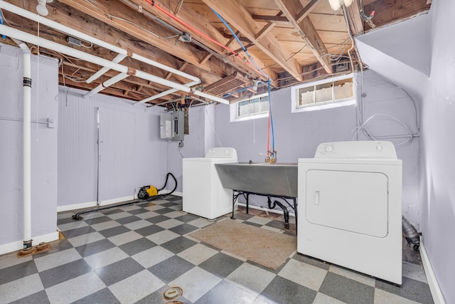 clothes washing area featuring separate washer and dryer, electric panel, and sink