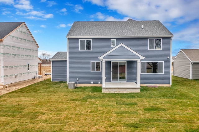 back of property with a lawn and a patio area