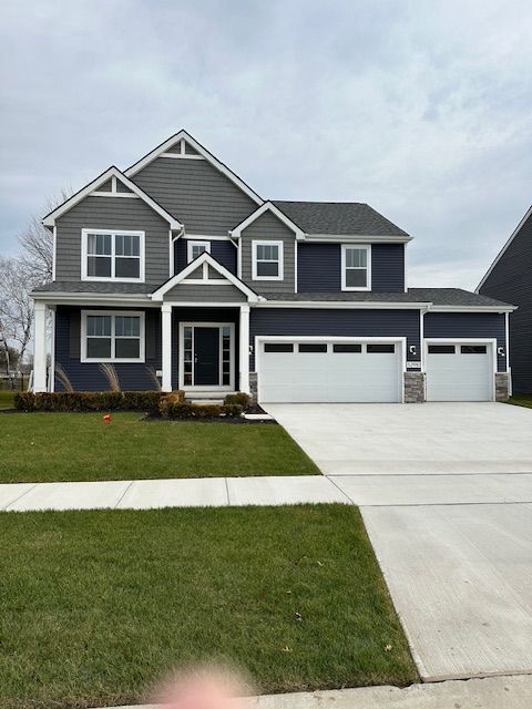 view of front facade with a front lawn and a garage