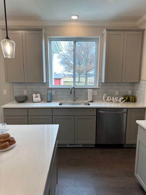 kitchen with gray cabinets, dishwasher, pendant lighting, and sink