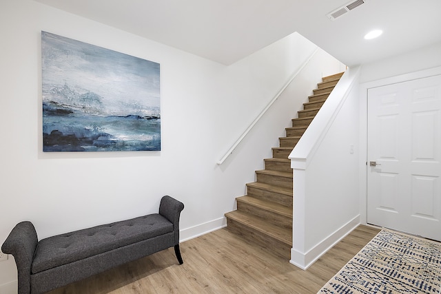 stairway with hardwood / wood-style flooring