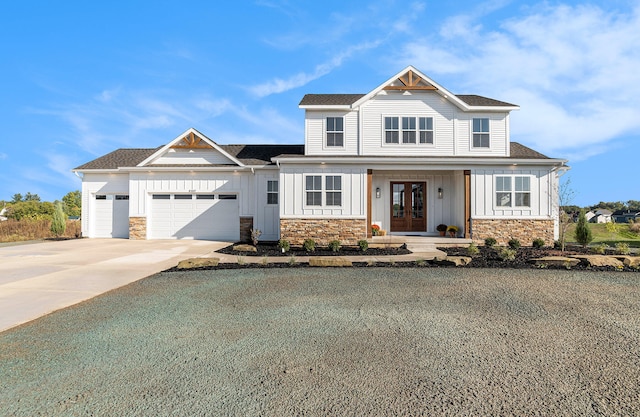 view of front facade with a garage and french doors