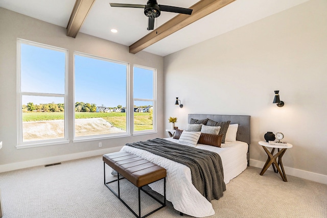 bedroom featuring beamed ceiling, ceiling fan, and light carpet