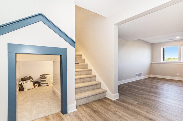 stairway with hardwood / wood-style floors