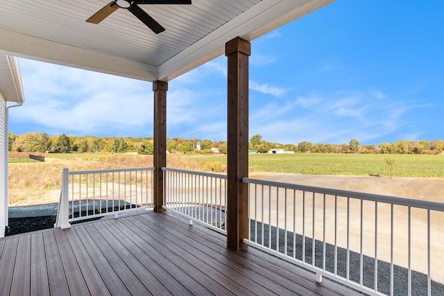 wooden terrace featuring ceiling fan and a rural view