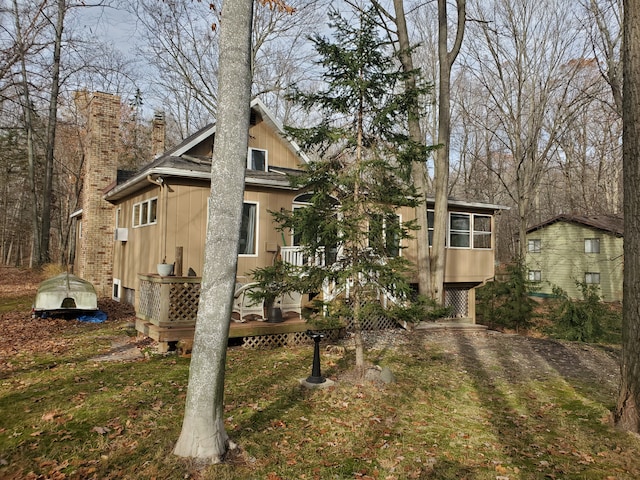 back of house with a sunroom and a yard