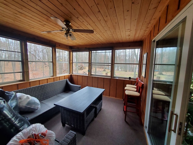 sunroom / solarium with wooden ceiling and ceiling fan