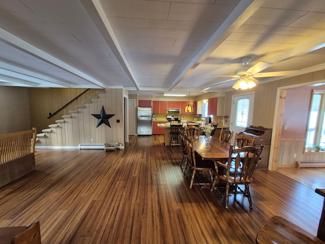 dining area with beam ceiling, wood-type flooring, and baseboard heating