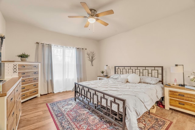 bedroom with ceiling fan and light hardwood / wood-style flooring