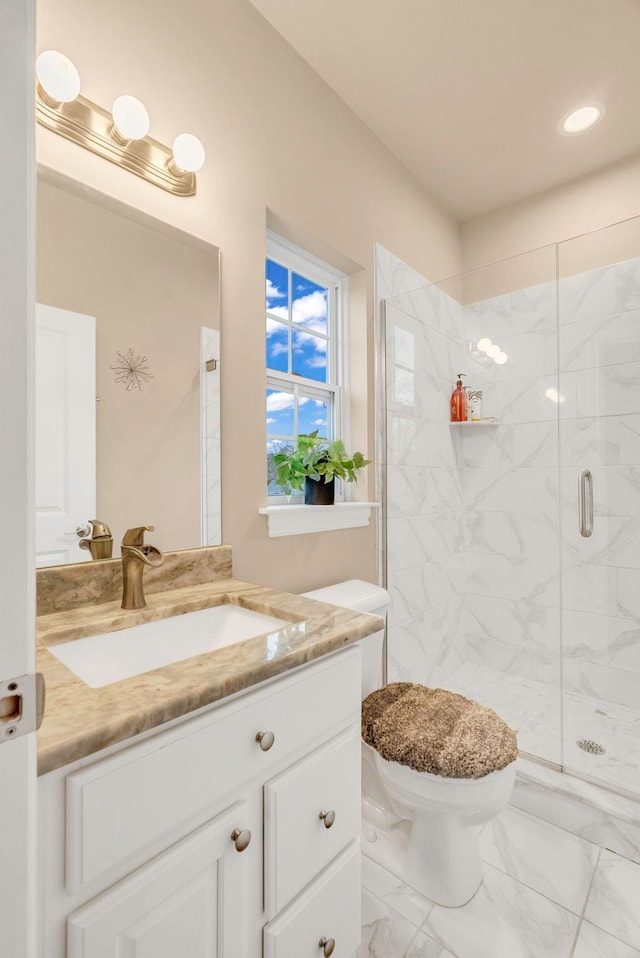 bathroom featuring vanity, toilet, and an enclosed shower