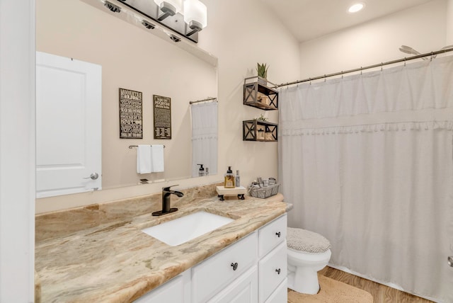 bathroom featuring hardwood / wood-style floors, vanity, and toilet