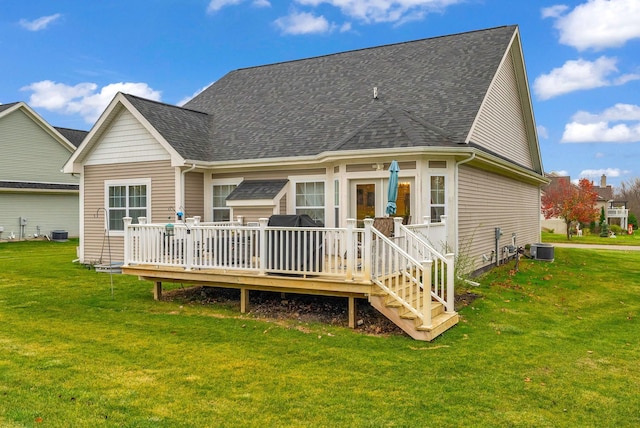 rear view of property featuring a lawn, a deck, and central AC