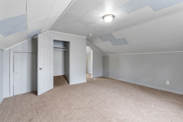 additional living space with light carpet and lofted ceiling