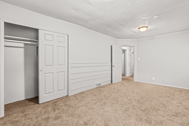 unfurnished bedroom with a closet and carpet floors