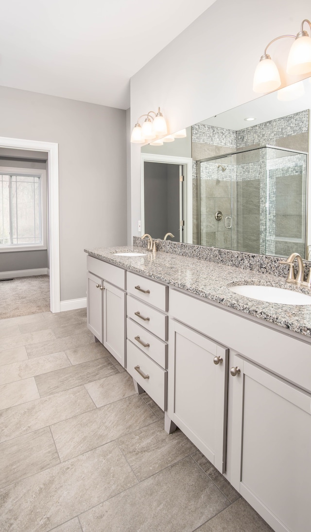 bathroom with vanity and a shower with shower door