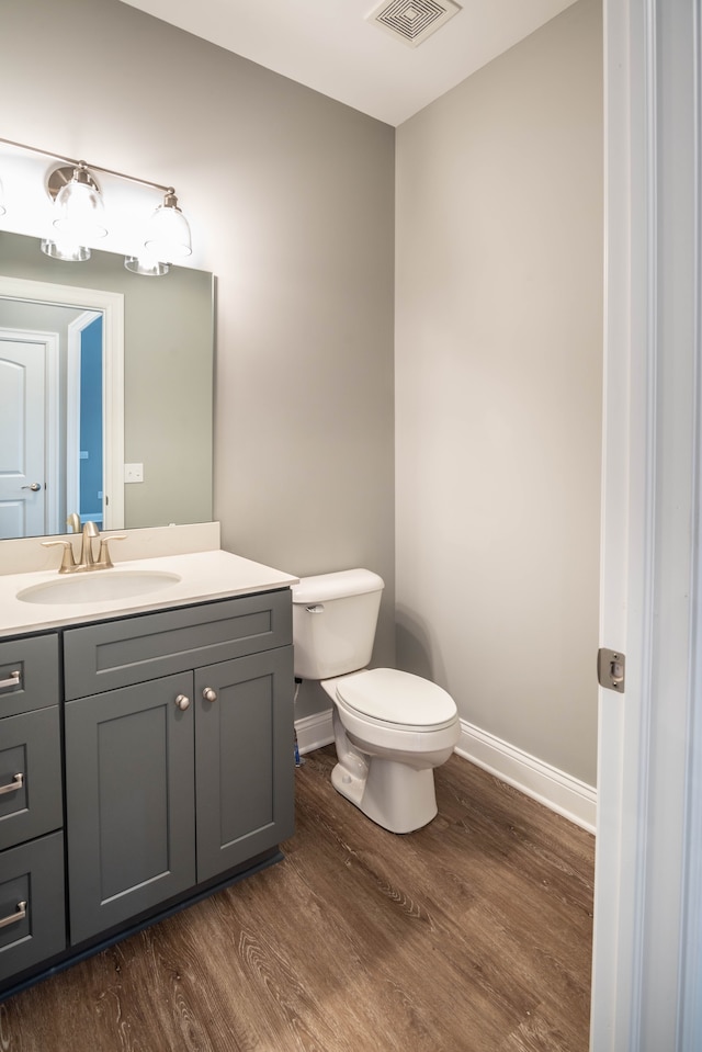 bathroom featuring hardwood / wood-style flooring, vanity, and toilet