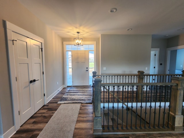 entrance foyer with a chandelier and dark wood-type flooring