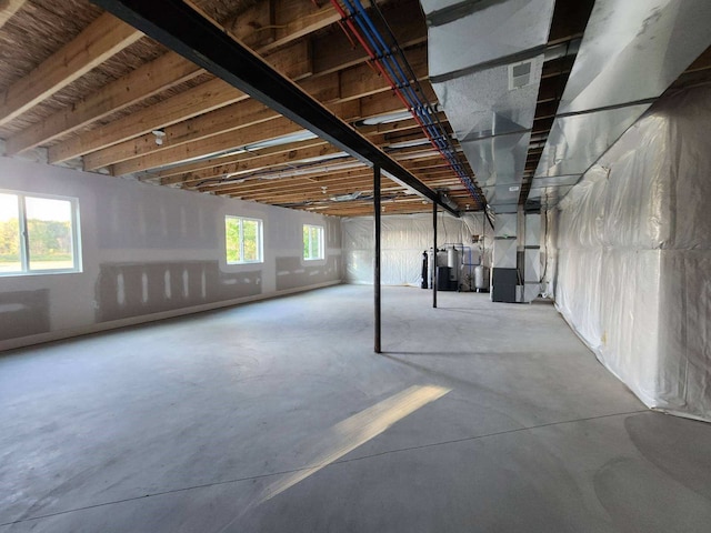 basement with heating unit and a wealth of natural light