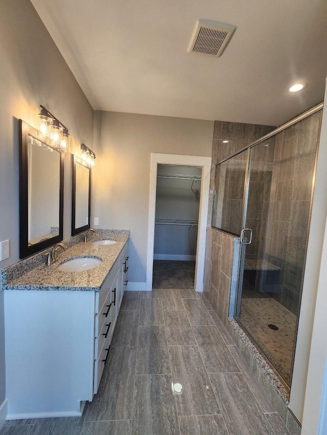 bathroom with vanity and an enclosed shower