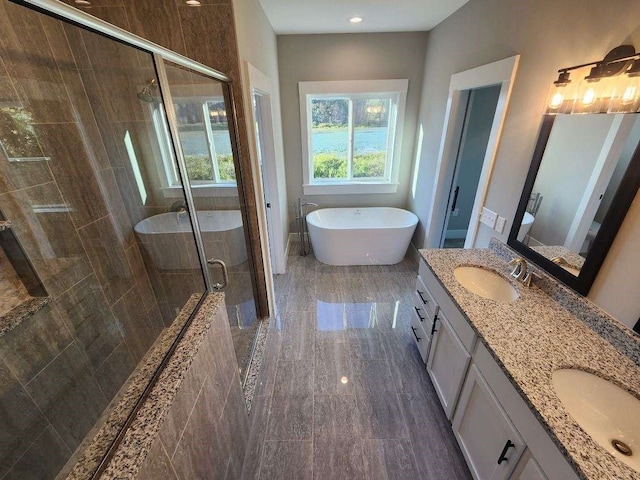 bathroom with vanity and independent shower and bath