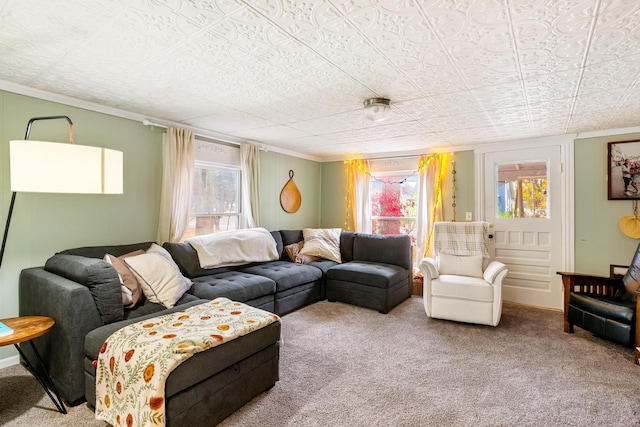 living room featuring plenty of natural light, carpet floors, and ornamental molding