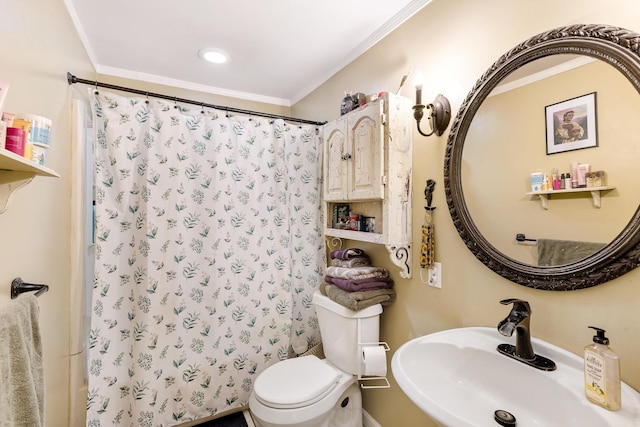 bathroom featuring toilet, walk in shower, ornamental molding, and sink