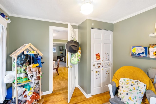 rec room featuring light hardwood / wood-style floors and ornamental molding