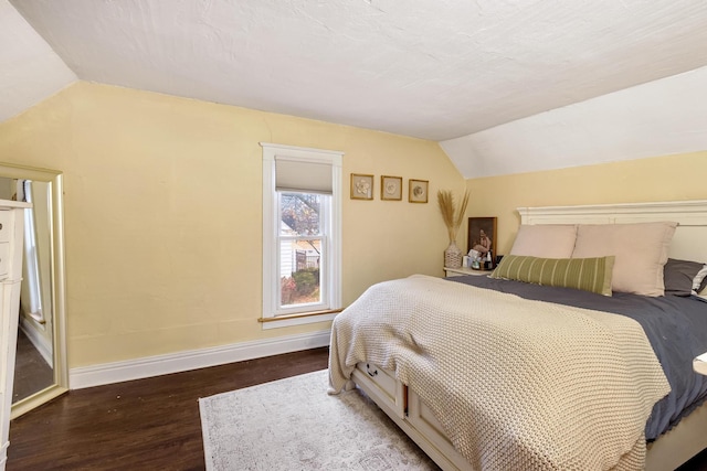 bedroom with dark hardwood / wood-style floors and lofted ceiling