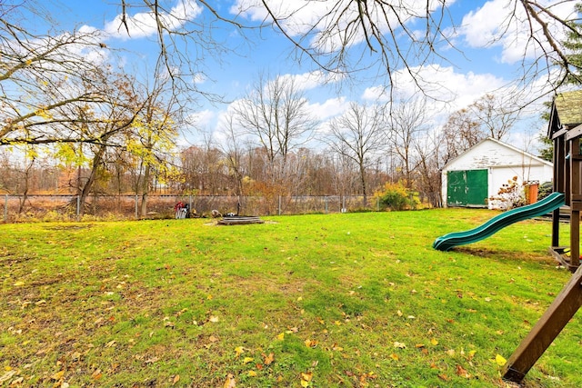 view of yard with a playground and a shed