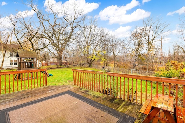 wooden terrace with a yard and a playground